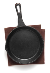 Empty iron pan and napkin isolated on white background