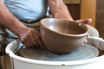 Fototapeta na wymiar Potter working with clay on wheel.