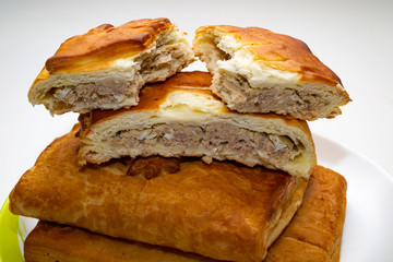 tasty meat pies on a plate.