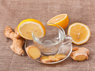 Healthy ginger tea with lemon on a jute napkin.