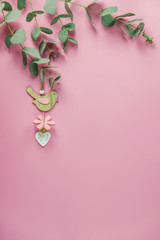Eucalyptus leaves on pink background. Frame made of eucalyptus branches. Valentine's day, Mother's day, Happy Easter, Womans Day concept. Flat lay, top view, copy space