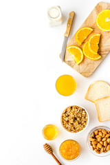 Morning granola near toast and oranges on white background top-down frame copy space