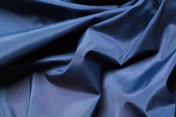 Fototapeta premium Blue fabric cloth texture. abstract texture background with soft waves.