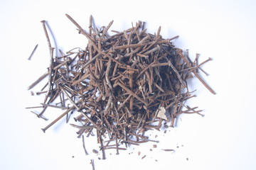 photo of hundreds of rusty nails on white background.