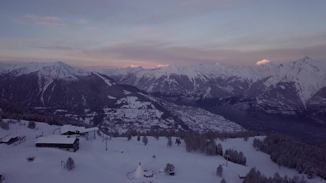 Sunrise Scenery In The Snow Covered Peaks Of The Swiss Alps - aerial shot