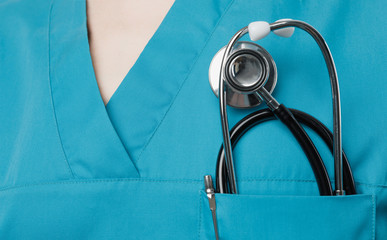 Medicine, insurance and healthcare concept. Stethoscope in surgeon doctor pocket green coat,...
