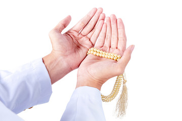 Muslim man praying with prayer beads on his hands