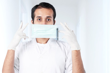 Asian doctor man in protective gloves wearing flu