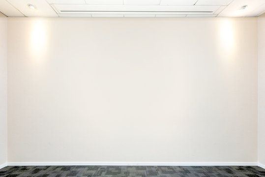 Meeting room with lights and empty wall