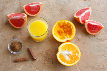 Organic foods orange, grapefruit, juice and aromatic cinnamon. Brown background.