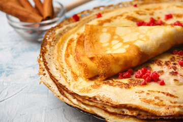 Delicious Russian pancakes with sour cream and honey cooked for Shrovetide celebration