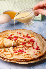 Delicious Russian pancakes with sour cream and honey cooked for Shrovetide celebration