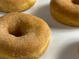 Donuts with cinnamon sugar-coated, on a white background