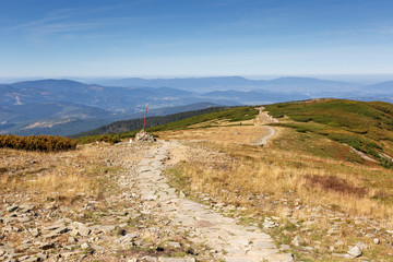 Hiking path to Babia Gora Mountain in Poland under blue sky in summer, polish Beskid Mountains landscape with path