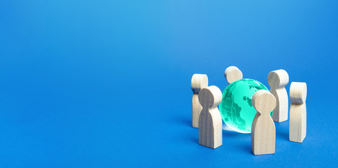Blue earth globe is surrounded by people. Global communication, cooperation and collaboration....