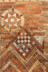 Ancient brick wall of the Basilica of Santo Stefano also called the Seven Churches in early Christian, Romanesque and Gothic style. Bologna, Emilia-Romagna, Italy, Europe