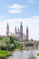 Naklejka premium Nuestra Senora del Pilar is dedicated to the Virgin Mary and named after her alleged appearance in these places around 40 CE.Stone Bridge on the Ebro River.