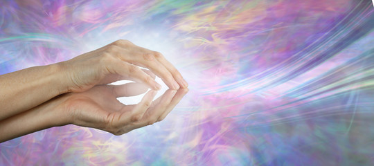 Healing practitioner sensing healing energy vibes - female cupped hands with a whoosh of white...
