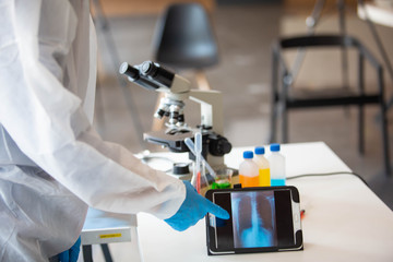 The doctor is testing a sample of biological tubes contaminated by Corona-virus Covid 19 and searching for a vaccine against the virus. In the laboratory and film samples of infected lung