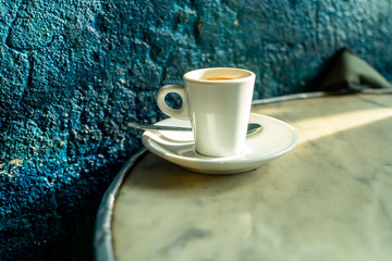 Cup of coffee in a nice hipster cafe. Soft focused image. Cup of espresso on old table of...