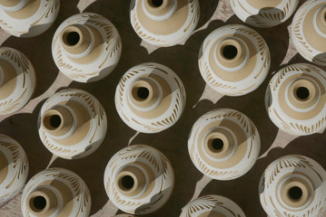 Top view of handmade traditional Malay craft known as 'labu sayong' dry in the sun. It is a hand...