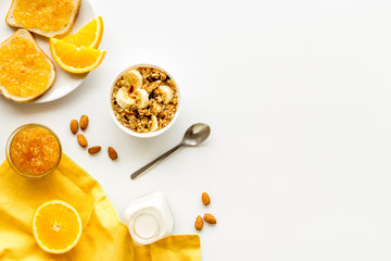 Vegetarian breakfast with granola and fruits on white background top-down frame copy space