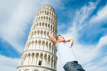 Portrait of tired tourist using the Leaning Tower of Pisa to for some rest and relaxation