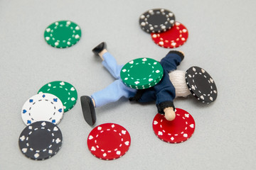 Concept .. Complete loss. A man lies under poker chips. Psychological training