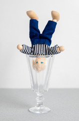 Concept .. Alcoholism. A man in a glass of vodka is upside down. Psychological training