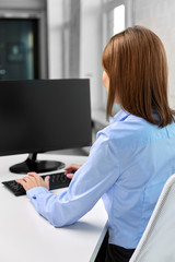 business, technology and people concept - businesswoman with computer working at office