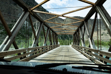 driving a camper over a wooden bridge in provincial park, British Columbia, Canada
