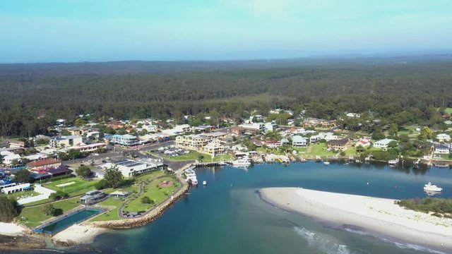 Aerial drone view of Huskisson on the New South Wales South Coast, Australia, showing Currambene Creek and Jervis Bay on a bright sunny day   