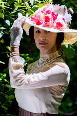 Elegant lady, from high society of the twentieth century, walking through a public park