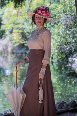 Elegant lady, from high society of the twentieth century, walking through a public park