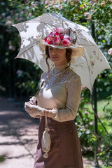 Elegant lady, from high society of the twentieth century, walking through a public park