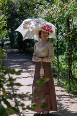 Elegant lady, from high society of the twentieth century, walking through a public park