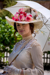 Elegant lady, from high society of the twentieth century, walking through a public park
