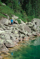 a girl walking near the lake