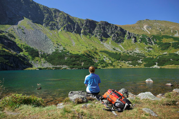 Fototapeta premium a girl with backpack near the lake