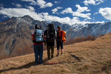 three tourists in the mountains