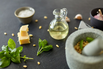food cooking and culinary concept - parmesan cheese, pine nuts, vinegar and garlic for basil pesto...
