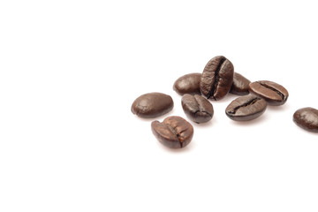 piled of coffee beans group roast dark brown textured isolated on white backgrounds