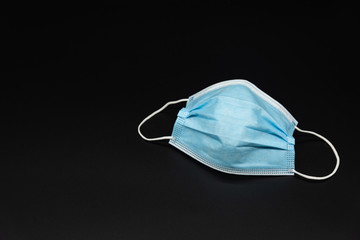 Single blue mask with copy space on black background