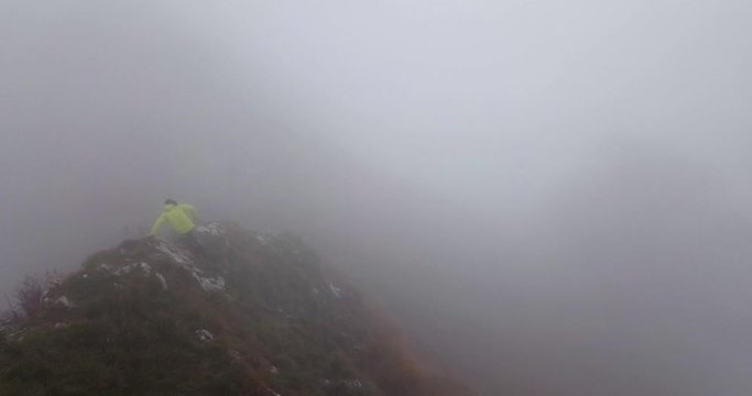 Man Running On The Trail In The Lush Valsassina Valley In Italy On A Foggy Day - Aerial Shot