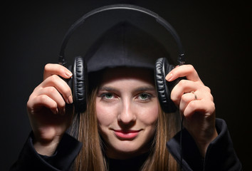 Girl In Hoodie Holding Headphones