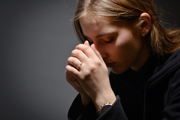 Woman Hands Praying With A Bible In Dark - obrazy, fototapety, plakaty