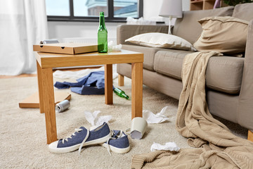 mess, disorder and interior concept - view of messy home living room with scattered stuff