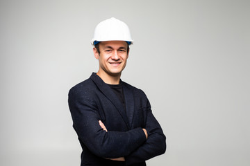 Portrait of happy young business man in helmet isolated on white background