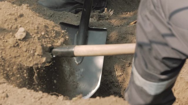 Workers dig ground with shovels dry soil gas accident leak repair emergency rescue service men in working uniform clothes