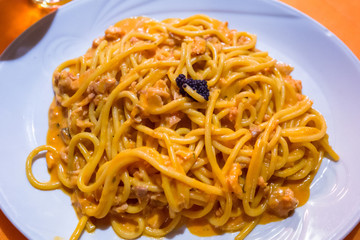 Spaghetti pasta with salmon sauce and seafood